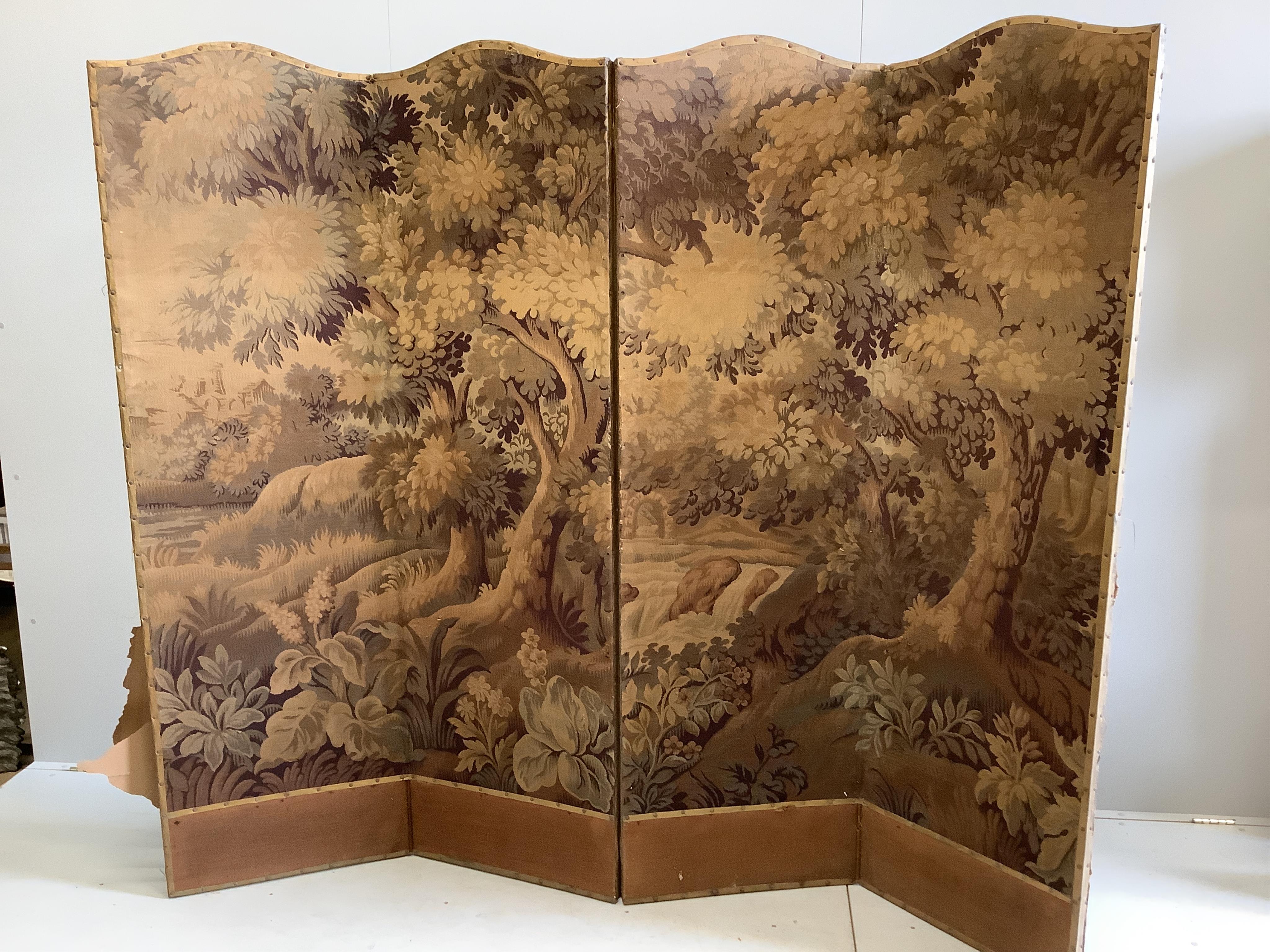 An Edwardian four fold draught screen, covered with a Brussels machine made woodland scene, each panel width 57cm, height 197cm. Condition - poor